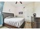 Bedroom features wood floors, large dresser, double door closet, and decorative moon art at 4608 Scott Rd, Lutz, FL 33558