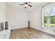 Bedroom featuring hardwood floors, and a large window at 4608 Scott Rd, Lutz, FL 33558