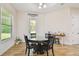 Bright dining room with wood floors, a round table, and access to the outdoors at 4608 Scott Rd, Lutz, FL 33558
