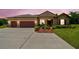 Beautiful single-story home with three-car garage, stone accents, mature landscaping, and ample driveway space at 4608 Scott Rd, Lutz, FL 33558