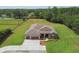 Aerial view of home with lush landscaping and three-car garage at 4608 Scott Rd, Lutz, FL 33558