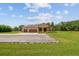 Charming single-story home boasts a three-car garage and beautiful landscaping in the front yard at 4608 Scott Rd, Lutz, FL 33558