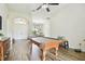 Spacious game room with wood-look tile floors, a pool table, and views into the dining area at 4608 Scott Rd, Lutz, FL 33558