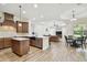 Open concept kitchen with granite countertops, dark wood cabinetry, and stainless steel appliances at 4608 Scott Rd, Lutz, FL 33558