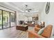 Open-concept living room with wood-look flooring flowing into the dining and kitchen areas at 4608 Scott Rd, Lutz, FL 33558