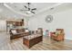 Open-concept living room with wood floors and view to kitchen at 4608 Scott Rd, Lutz, FL 33558
