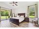 Spacious main bedroom with wood-look flooring and access to covered patio at 4608 Scott Rd, Lutz, FL 33558