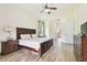 Comfortable main bedroom featuring a ceiling fan, wood-look tile floors, and ample natural light at 4608 Scott Rd, Lutz, FL 33558