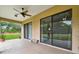 View of covered patio, ceiling fan, and sliding glass doors leading to the backyard at 4608 Scott Rd, Lutz, FL 33558