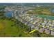 Expansive aerial shot of a community with lush foliage and winding streets near a beautiful lake at 5446 Suncatcher Dr, Wesley Chapel, FL 33545
