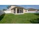 Large, well-maintained backyard with a screened-in patio and a white privacy fence at 5446 Suncatcher Dr, Wesley Chapel, FL 33545
