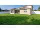 Spacious backyard featuring green lawn and a screened lanai, enclosed by a white fence at 5446 Suncatcher Dr, Wesley Chapel, FL 33545