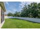 Expansive backyard with lush green grass and a white fence, perfect for outdoor activities at 5446 Suncatcher Dr, Wesley Chapel, FL 33545