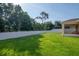 Well-maintained lawn with privacy fence and view of the screened patio and landscaping at 5446 Suncatcher Dr, Wesley Chapel, FL 33545