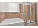 Relaxing bathroom featuring a separate tub and shower with tiled walls at 5446 Suncatcher Dr, Wesley Chapel, FL 33545