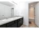 Bright bathroom featuring double sinks, granite countertop, dark cabinets, tub and shower at 5446 Suncatcher Dr, Wesley Chapel, FL 33545