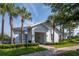 Charming community clubhouse with palm trees, well-manicured landscaping, and accessible parking at 5446 Suncatcher Dr, Wesley Chapel, FL 33545