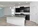 Stylish kitchen with sleek black cabinetry, stainless steel appliances, and a center island at 5446 Suncatcher Dr, Wesley Chapel, FL 33545