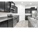 Updated kitchen featuring stainless steel appliances, granite countertops and dark wood cabinets at 5446 Suncatcher Dr, Wesley Chapel, FL 33545