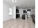 Open-concept kitchen with stainless steel appliances, granite countertops and dark wood cabinets at 5446 Suncatcher Dr, Wesley Chapel, FL 33545
