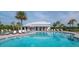 Community pool with lounge chairs and umbrellas for relaxing on a sunny day at 5446 Suncatcher Dr, Wesley Chapel, FL 33545