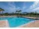 Sparkling community pool with lounge chairs, shade umbrellas, and a relaxing atmosphere at 5446 Suncatcher Dr, Wesley Chapel, FL 33545