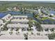 Aerial view of a residential neighborhood featuring townhomes alongside a serene lake at 580 Shoreham Ne Ct, St Petersburg, FL 33716