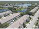 Scenic aerial view of townhomes nestled near a lake, highlighting the community's serene and natural surroundings at 580 Shoreham Ne Ct, St Petersburg, FL 33716