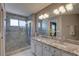 Modern bathroom with double vanities, granite countertops, and a glass-enclosed shower at 580 Shoreham Ne Ct, St Petersburg, FL 33716