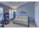 Cozy bedroom featuring a daybed, shuttered windows, and stylish decorative elements at 580 Shoreham Ne Ct, St Petersburg, FL 33716