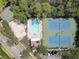Aerial view of community amenities with pool, tennis courts, and playground at 580 Shoreham Ne Ct, St Petersburg, FL 33716