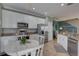 Bright eat-in kitchen featuring stainless steel appliances, granite countertops, and white cabinetry at 580 Shoreham Ne Ct, St Petersburg, FL 33716
