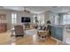 Comfortable living room with hardwood floors, shuttered windows, and an open layout to the eat-in kitchen at 580 Shoreham Ne Ct, St Petersburg, FL 33716