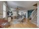 Inviting living room with hardwood floors, a ceiling fan, and ample natural light from shuttered windows at 580 Shoreham Ne Ct, St Petersburg, FL 33716