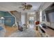 Open-concept living area featuring hardwood floors, comfortable seating, and a staircase at 580 Shoreham Ne Ct, St Petersburg, FL 33716