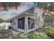 Exterior shot of the rear of the home featuring a screened porch and landscaped yard at 580 Shoreham Ne Ct, St Petersburg, FL 33716