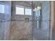 Modern bathroom features an upgraded shower with tile surround, a rain shower head, and built-in bench at 580 Shoreham Ne Ct, St Petersburg, FL 33716