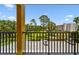 Balcony view of lush green space and peaceful pond at 5817 Park N St # 310, St Petersburg, FL 33709