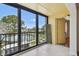 Enclosed balcony with tile floor offers a serene view of the community lake at 5817 Park N St # 310, St Petersburg, FL 33709