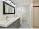 Bathroom showcasing double sink vanity and patterned tile floors at 5817 Park N St # 310, St Petersburg, FL 33709