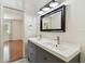 Bathroom featuring double sink vanity with a view to the bedroom at 5817 Park N St # 310, St Petersburg, FL 33709