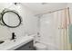 Bright bathroom features a large vanity, decorative mirror, and a shower with a white tiled surround at 5817 Park N St # 310, St Petersburg, FL 33709