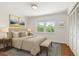 Well-furnished bedroom with a large window, closet, and area rug at 5817 Park N St # 310, St Petersburg, FL 33709