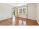 Bedroom with wood floors, large window, and door to the balcony at 5817 Park N St # 310, St Petersburg, FL 33709