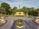 Main community entrance with prominent signage, lush landscaping, and decorative features at 5817 Park N St # 310, St Petersburg, FL 33709
