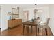 Dining room featuring wood floors, decorative furnishings, and an adjacent kitchen at 5817 Park N St # 310, St Petersburg, FL 33709