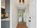 A freshly painted foyer with wood floors, and a view of the adjacent kitchen and balcony at 5817 Park N St # 310, St Petersburg, FL 33709