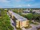 Exterior view of a well-maintained condo building, surrounded by mature trees and manicured landscaping at 5817 Park N St # 310, St Petersburg, FL 33709