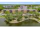 Exterior view of condo building, showcasing water views and beautiful lush trees and landscaping at 5817 Park N St # 310, St Petersburg, FL 33709