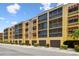 Condominium building featuring convenient garage parking and colorful tropical landscaping at 5817 Park N St # 310, St Petersburg, FL 33709